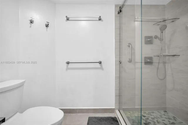 a bathroom with a toilet and a shower