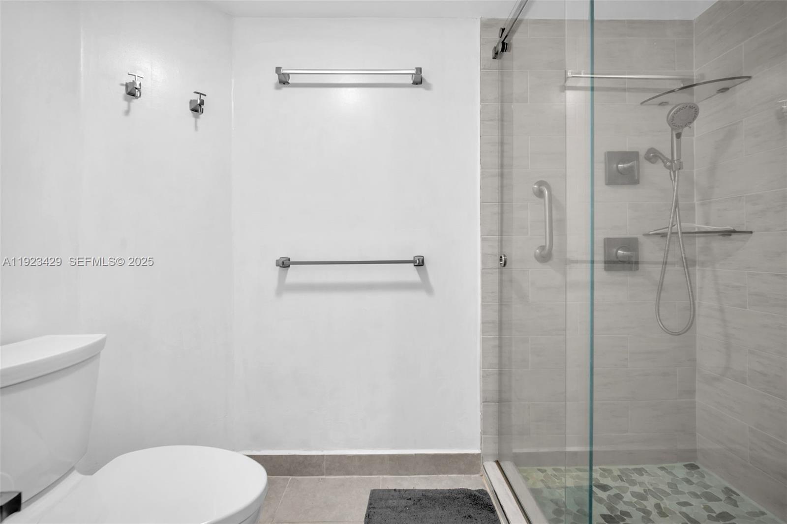 701 Southwest 142nd Avenue, Unit 414S Pembroke Pines, FL 33027 - Photo 27 of 30 a bathroom with a toilet and a shower