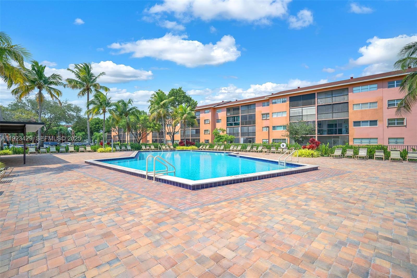 701 Southwest 142nd Avenue, Unit 414S Pembroke Pines, FL 33027 - Photo 29 of 30 a view of a swimming pool with a patio
