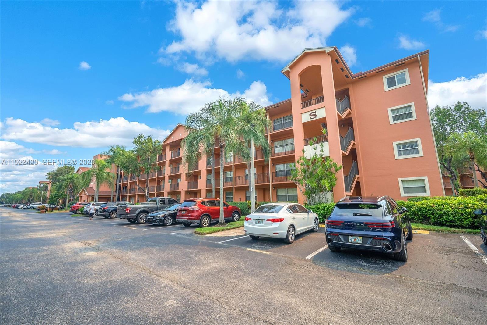 701 Southwest 142nd Avenue, Unit 414S Pembroke Pines, FL 33027 - Photo 4 of 30 a car parked in front of a brick house