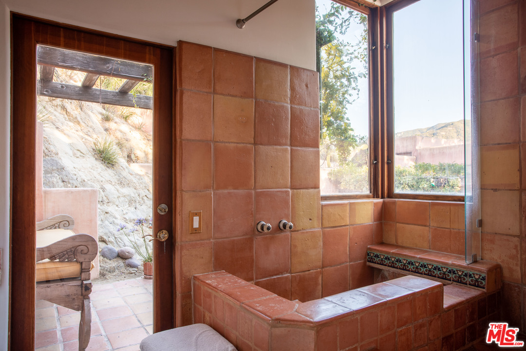 23407 Red Rock Road Topanga, CA 90290 - Photo 14 of 41 a bathroom with a tub and shower