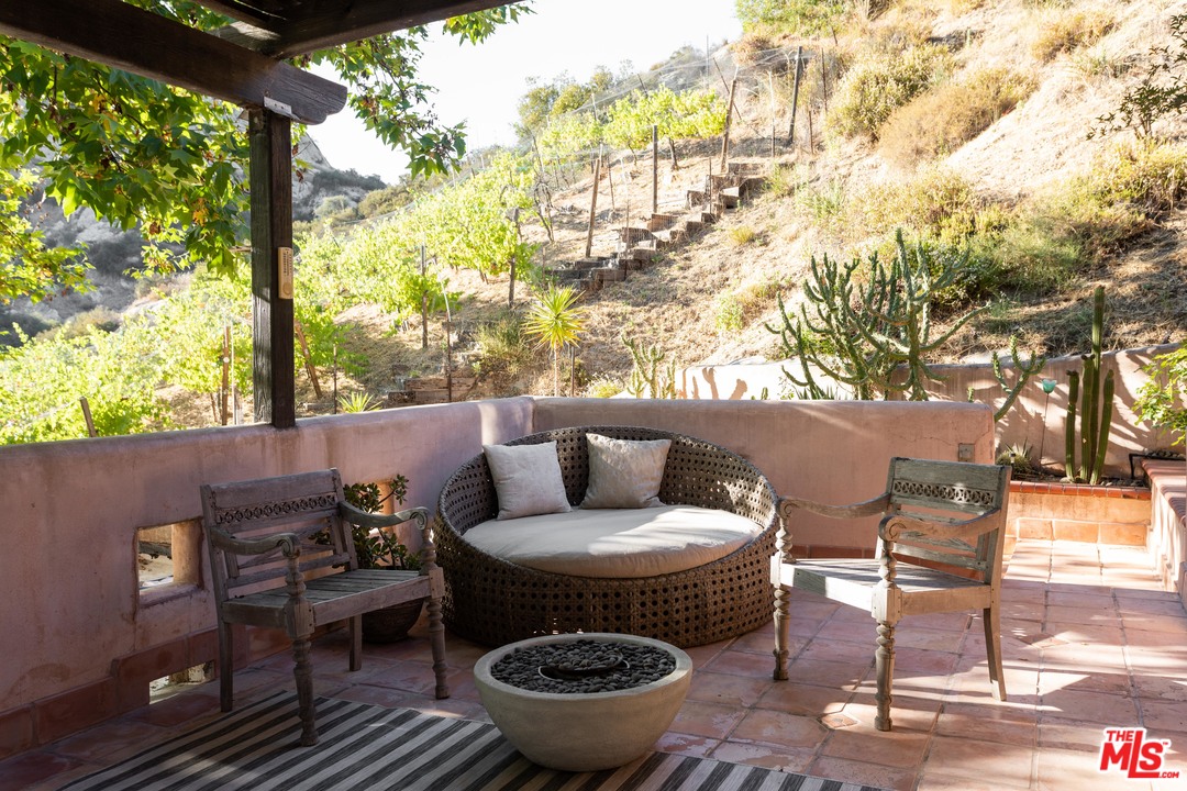 23407 Red Rock Road Topanga, CA 90290 - Photo 15 of 41 a backyard of a house with table and chairs