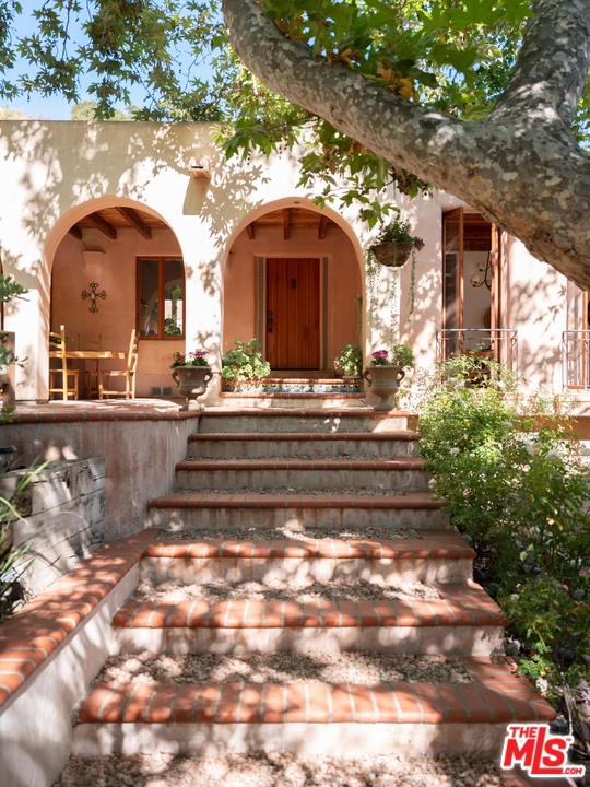 23407 Red Rock Road Topanga, CA 90290 - Photo 25 of 41 a front view of a house with a garden
