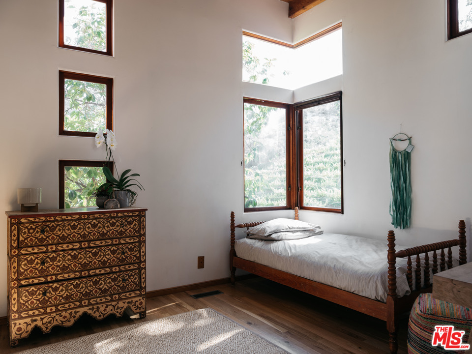 23407 Red Rock Road Topanga, CA 90290 - Photo 27 of 41 a bedroom with a bed and a window