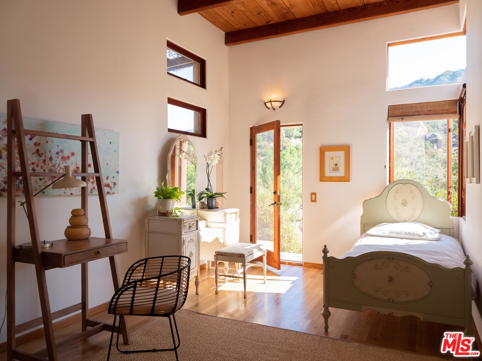 23407 Red Rock Road Topanga, CA 90290 - Photo 29 of 41 a living room with furniture and a floor to ceiling window