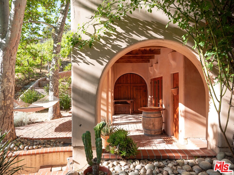 23407 Red Rock Road Topanga, CA 90290 - Photo 30 of 41 a front view of a house with garden