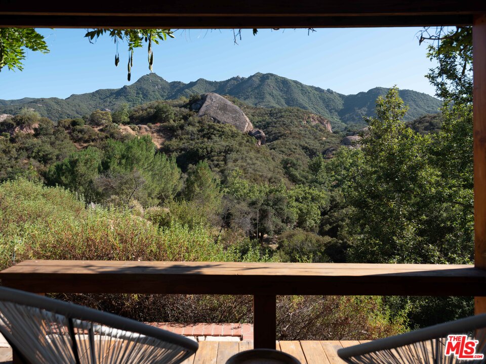23407 Red Rock Road Topanga, CA 90290 - Photo 34 of 41 a view of a lot of a green mountain from a balcony