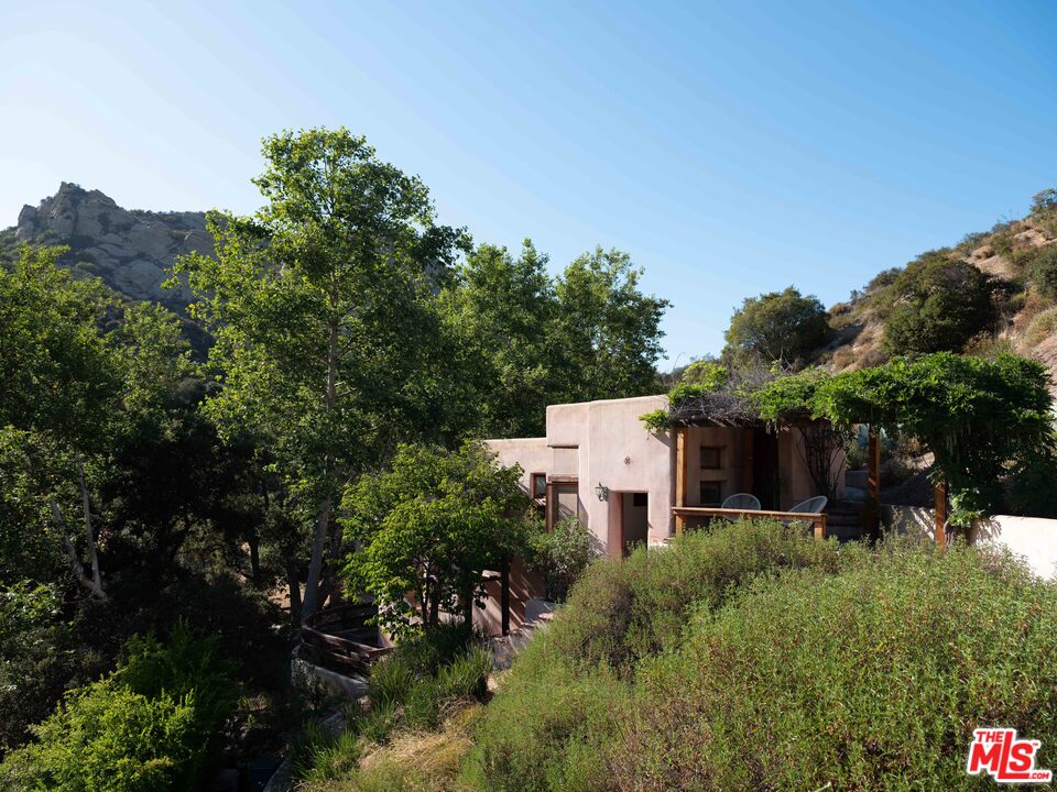 23407 Red Rock Road Topanga, CA 90290 - Photo 36 of 41 a view of a house with a yard and sitting area