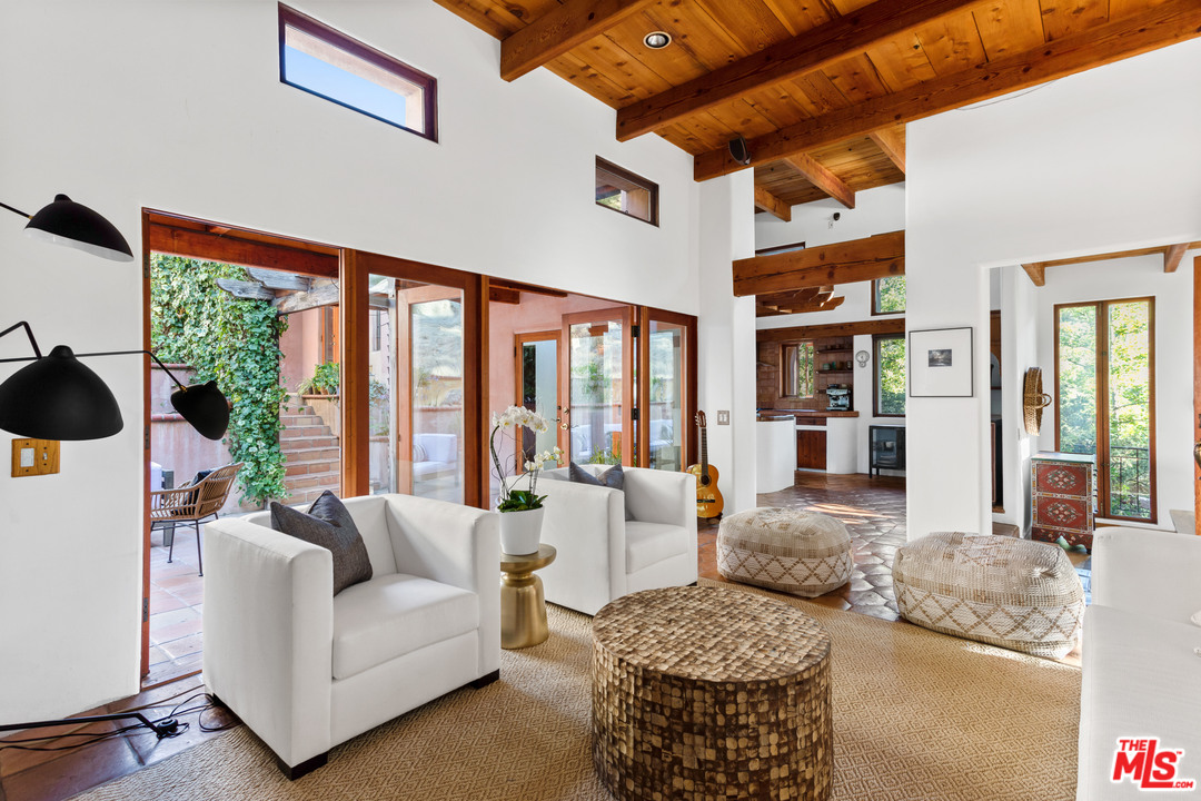 23407 Red Rock Road Topanga, CA 90290 - Photo 5 of 41 a living room with furniture and large windows