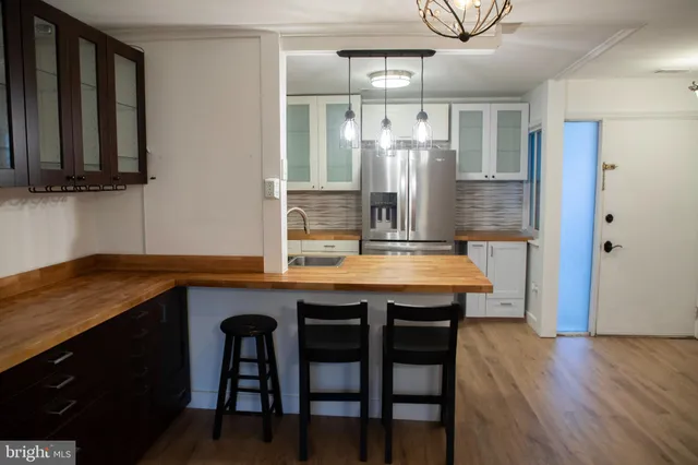 a bathroom with a toilet a sink a vanity and mirror