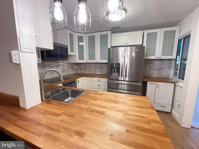 a bathroom with a sink mirror toilet and bathtub