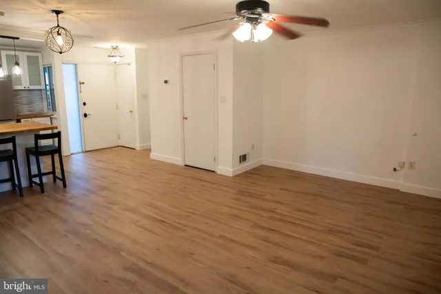 a kitchen with stainless steel appliances granite countertop a refrigerator a sink and white cabinets