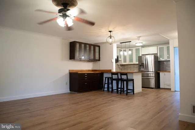 a kitchen with a refrigerator a sink and a stove top oven