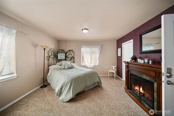 a bedroom with a bed and a fireplace