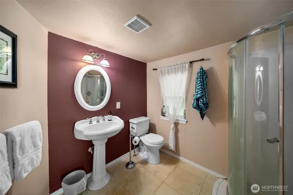 a bathroom with a toilet sink and mirror