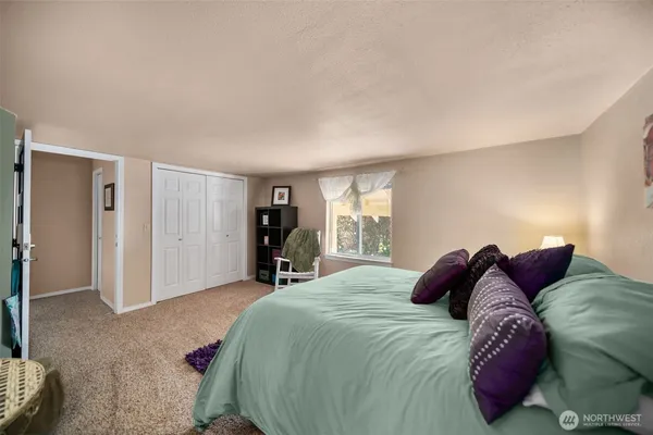 a bedroom with a bed and a window