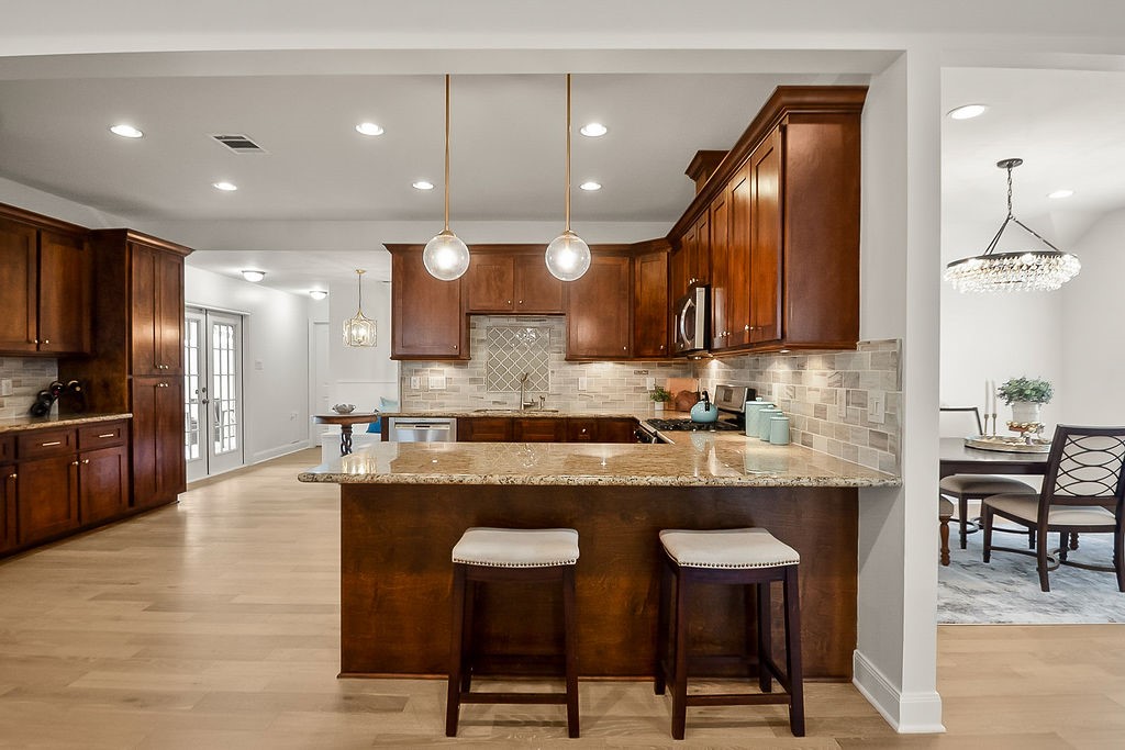 1731 Lamonte Lane Houston, TX 77018 - Photo 12 of 40 a large kitchen with cabinets chairs and wooden floor