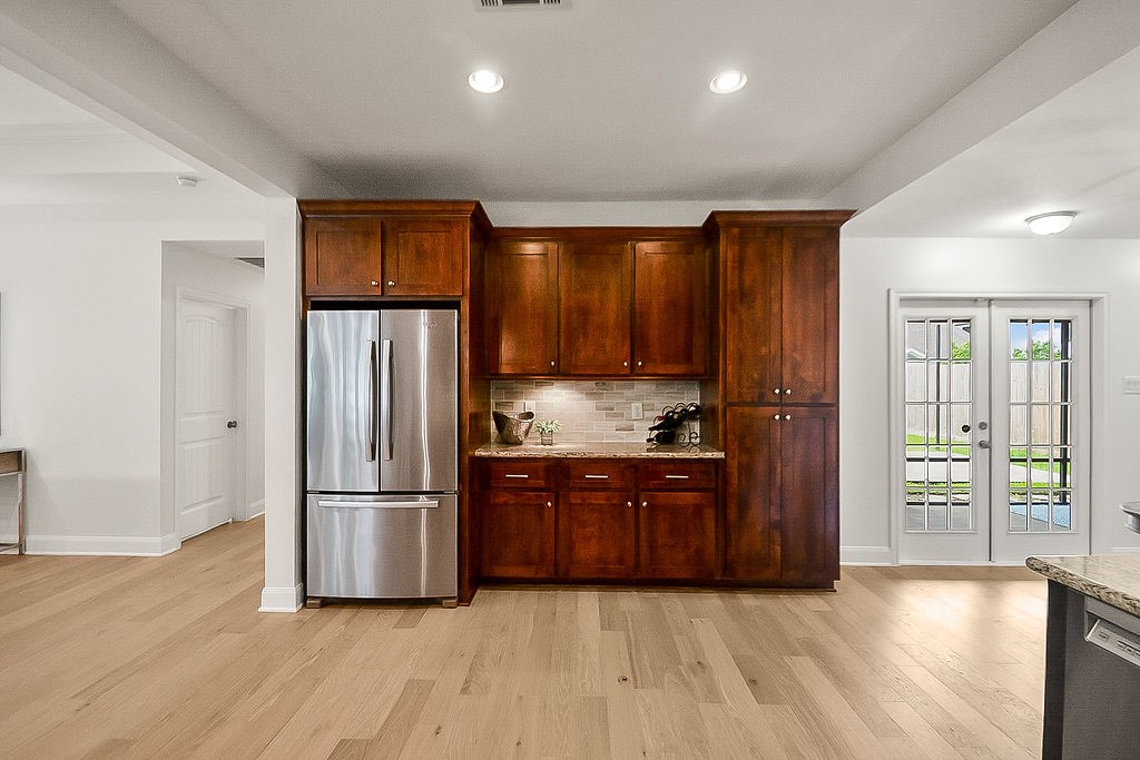 1731 Lamonte Lane Houston, TX 77018 - Photo 16 of 40 a kitchen with granite countertop wooden floors and stainless steel appliances