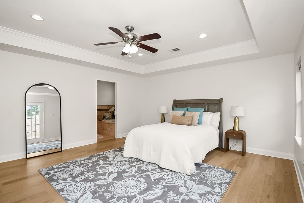 1731 Lamonte Lane Houston, TX 77018 - Photo 18 of 40 a bedroom with a bed and a dresser with wooden floor