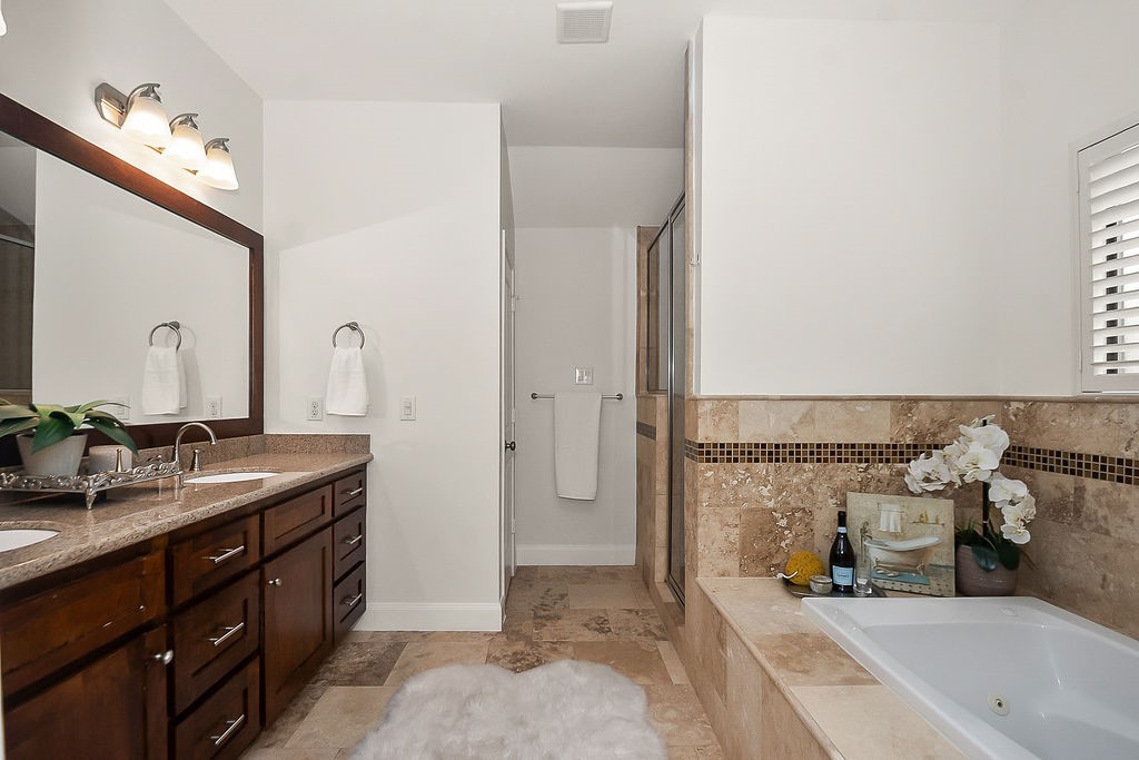 1731 Lamonte Lane Houston, TX 77018 - Photo 22 of 40 a spacious bathroom with a granite countertop sink and a mirror