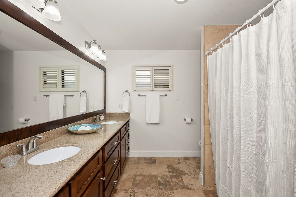1731 Lamonte Lane Houston, TX 77018 - Photo 27 of 40 a bathroom with a granite countertop sink and a mirror
