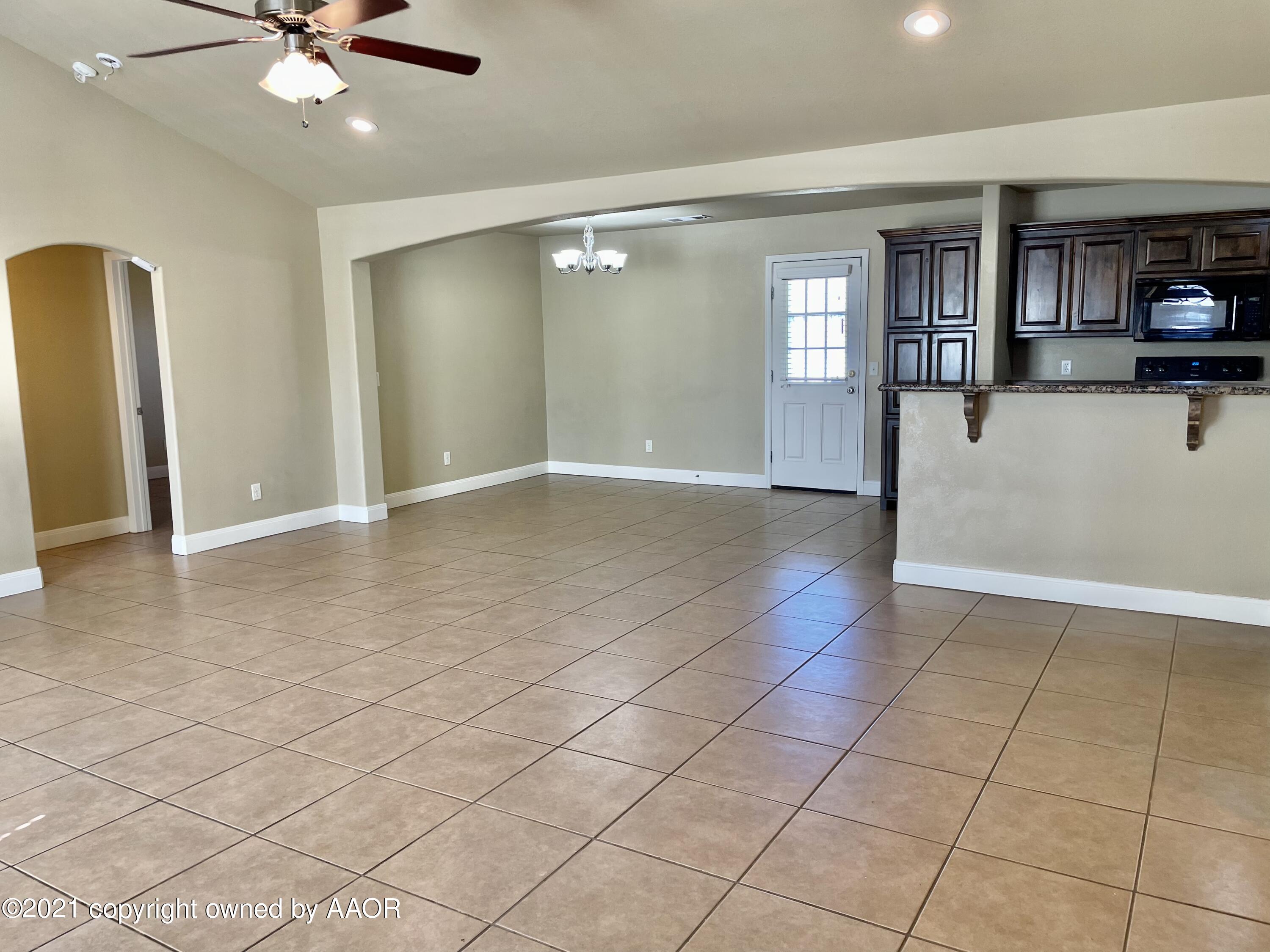 9812 Perry Avenue Amarillo, TX 79119 - Photo 1 of 15 a view of livingroom with hardwood floor and a ceiling fan