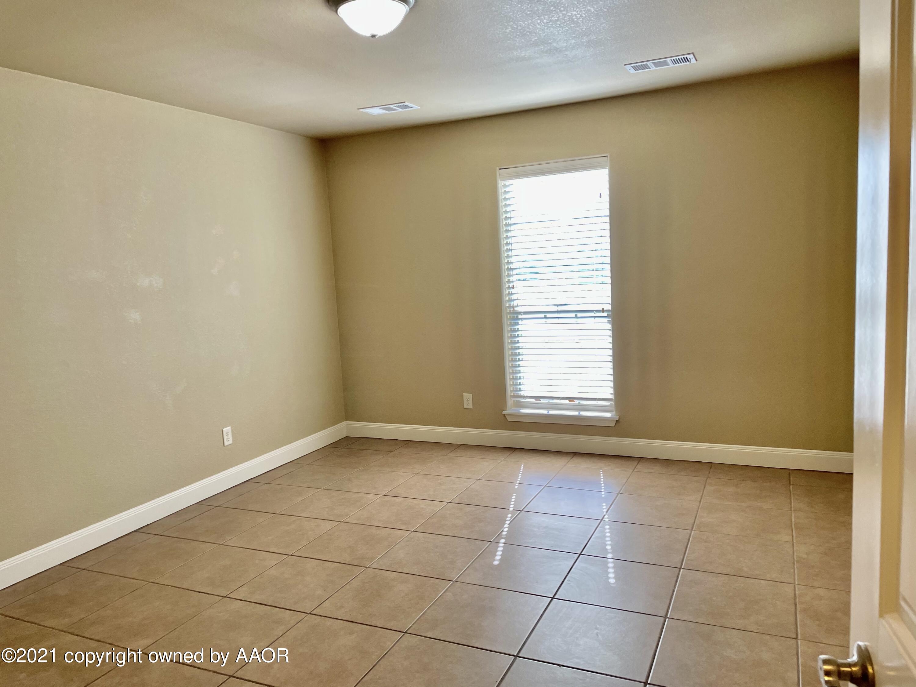 9812 Perry Avenue Amarillo, TX 79119 - Photo 11 of 15 a view of an empty room with a window