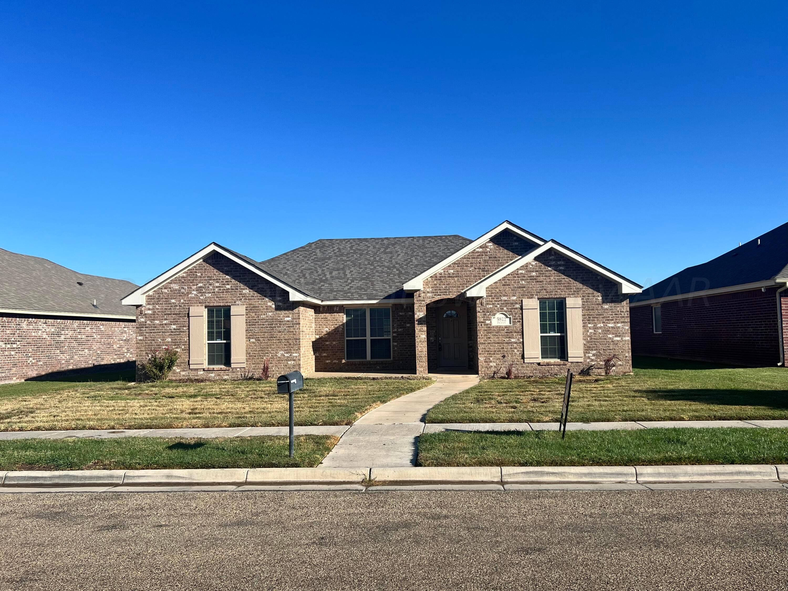 9812 Perry Avenue Amarillo, TX 79119 - Photo 12 of 15 a front view of a house with a yard