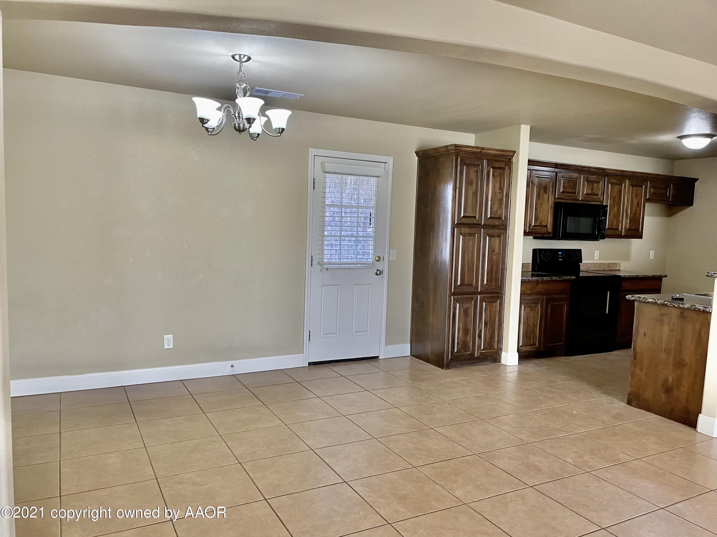 9812 Perry Avenue Amarillo, TX 79119 - Photo 5 of 15 a view of kitchen with refrigerator and cabinets