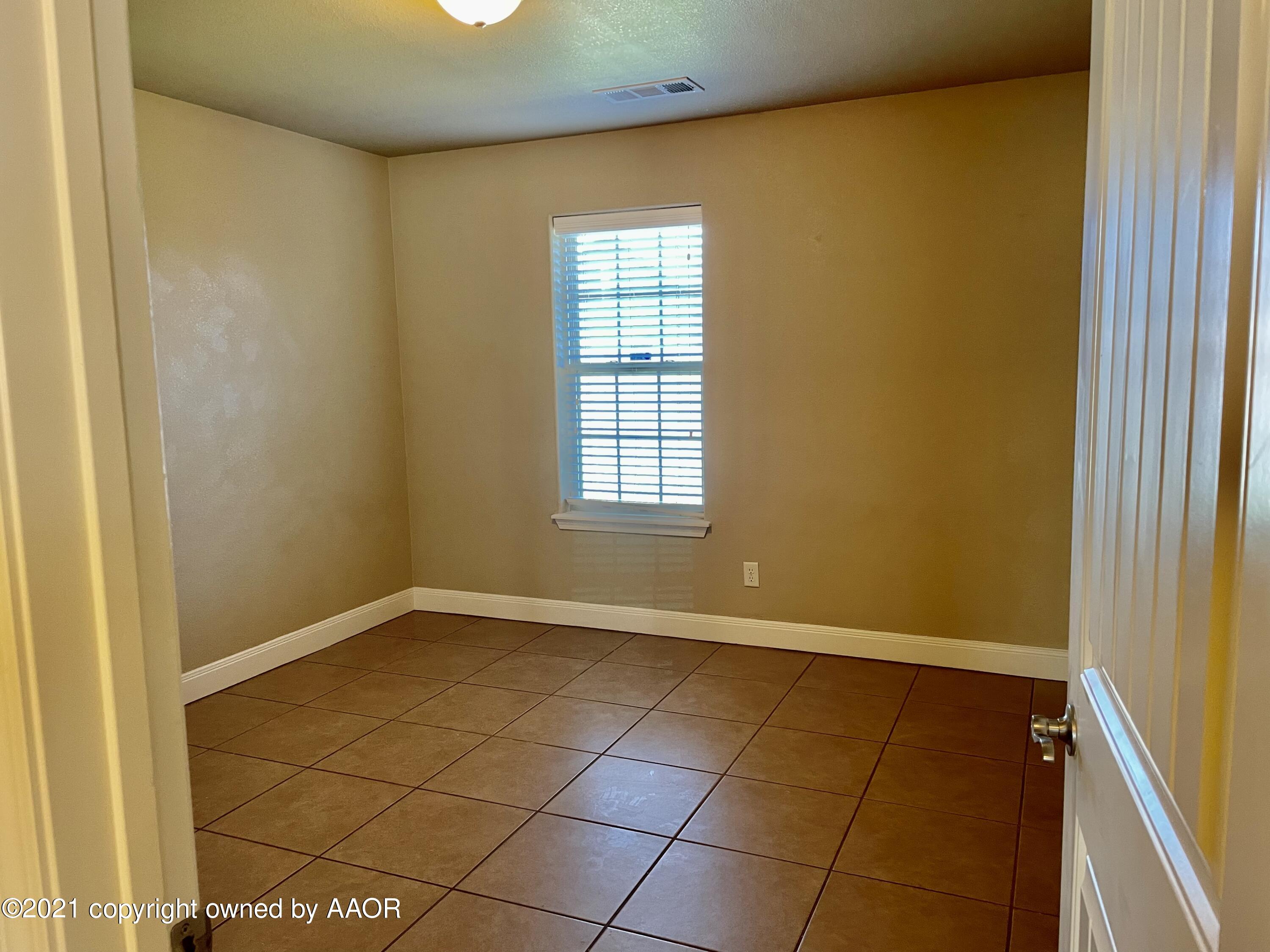 9812 Perry Avenue Amarillo, TX 79119 - Photo 6 of 15 a view of an empty room with a window