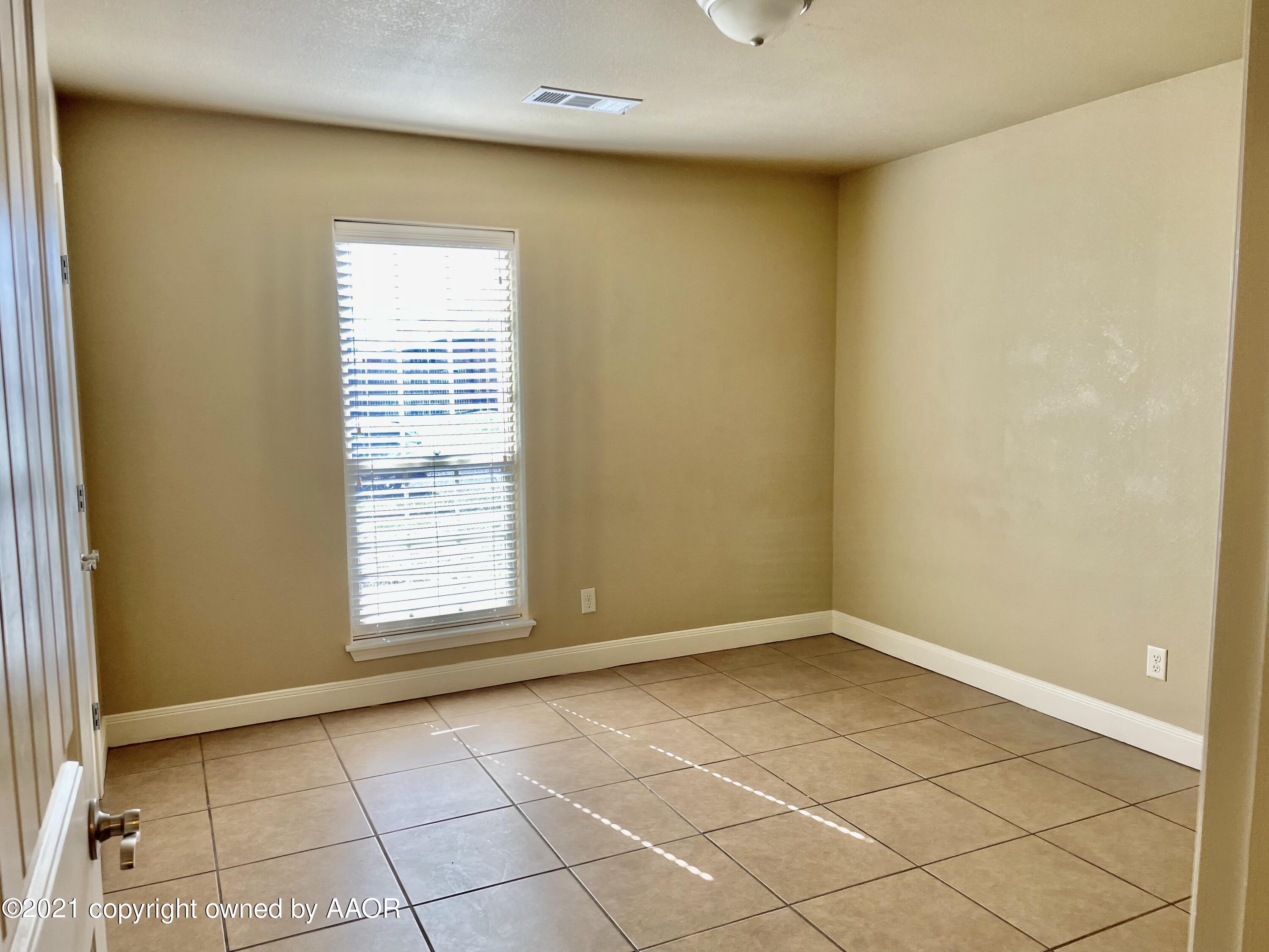 9812 Perry Avenue Amarillo, TX 79119 - Photo 9 of 15 a view of an empty room with a window