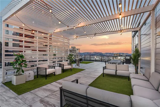 a large kitchen with stainless steel appliances kitchen island granite countertop a sink dishwasher stove and cabinets