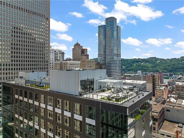 a lobby with furniture and potted plants