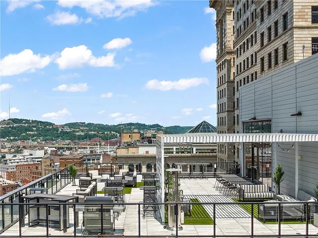 a view of a patio with couches table and chairs and potted plants