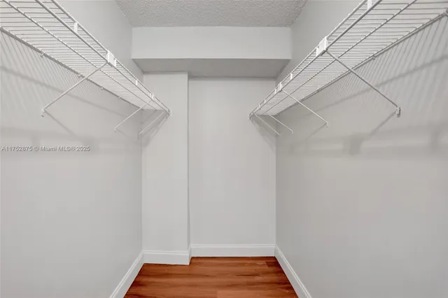 a bathroom with a bathtub shower sink and mirror