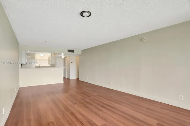a view of a kitchen with a sink a stove and cabinets