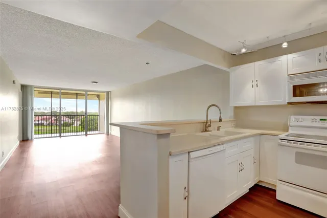 a kitchen with a refrigerator a sink and dishwasher