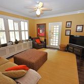 a living room with furniture a flat screen tv and a large window