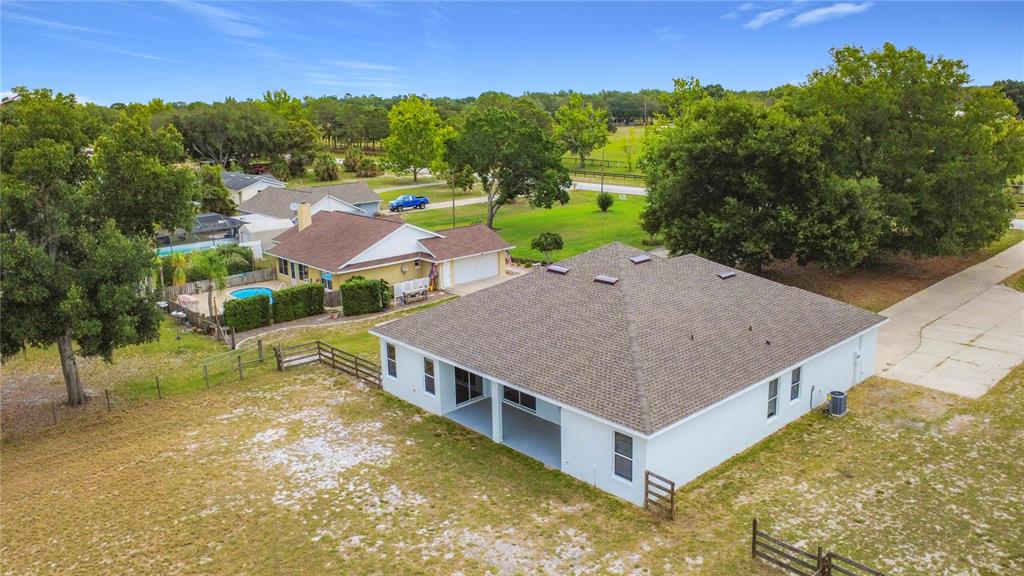 28549 Shirley Shores Road Tavares, FL 32778 - Photo 61 of 65 a aerial view of a house with swimming pool and trees in the background