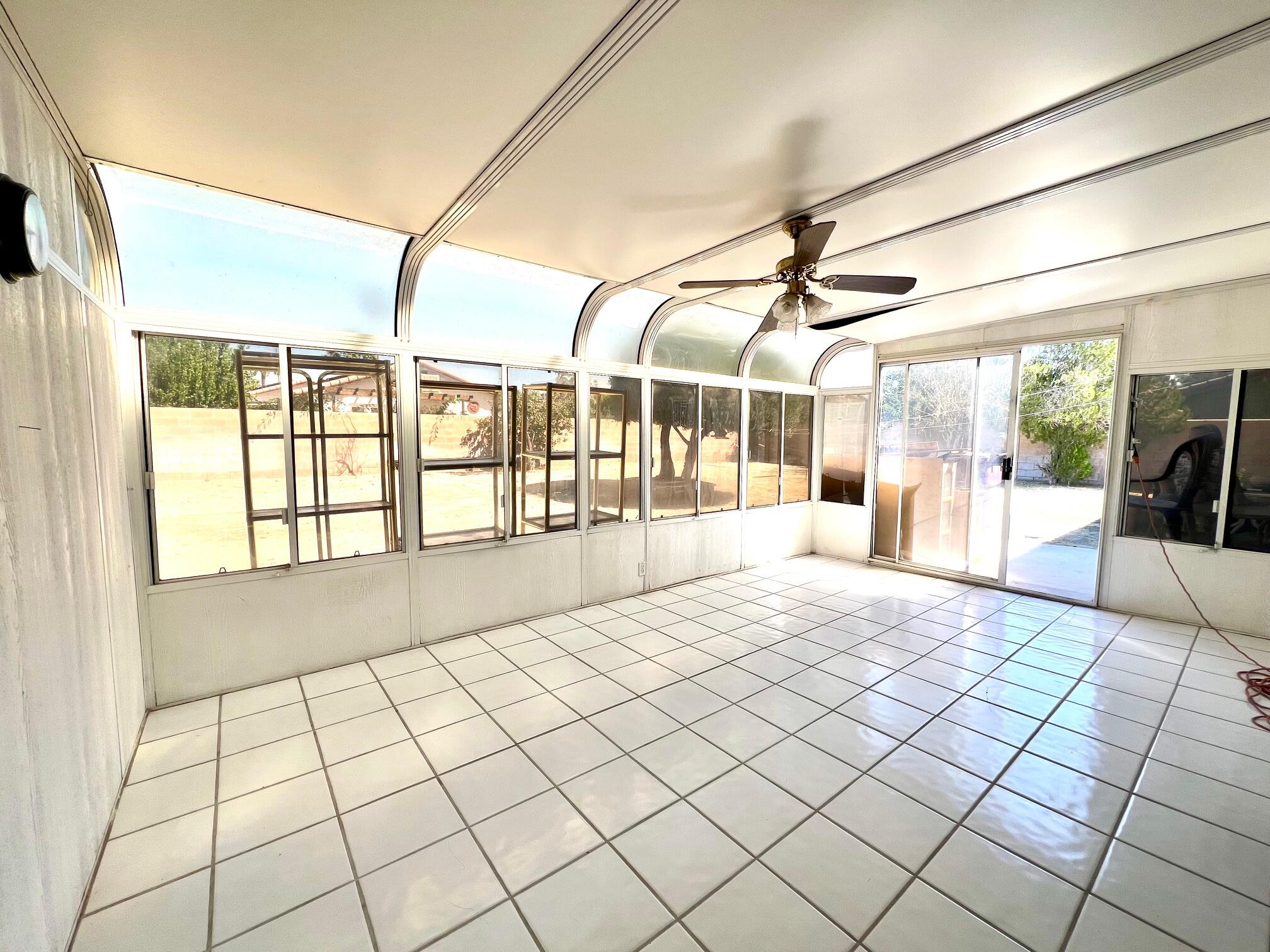 67690 Peineta Road Cathedral City, CA 92234 - Photo 2 of 7 a spacious bedroom with a large bed and a large window