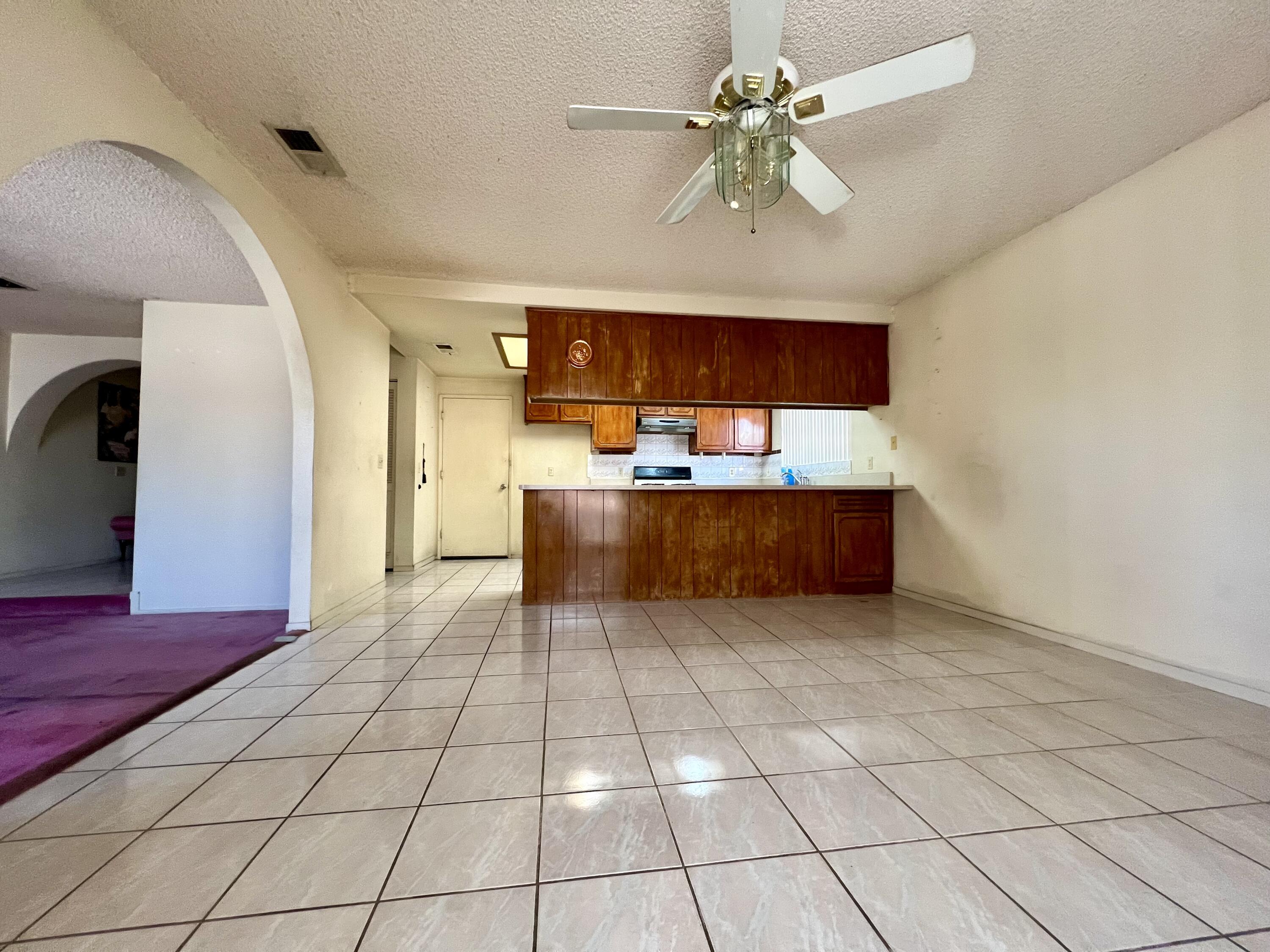 67690 Peineta Road Cathedral City, CA 92234 - Photo 3 of 7 a large kitchen with stainless steel appliances a stove a sink cabinets and a dining table