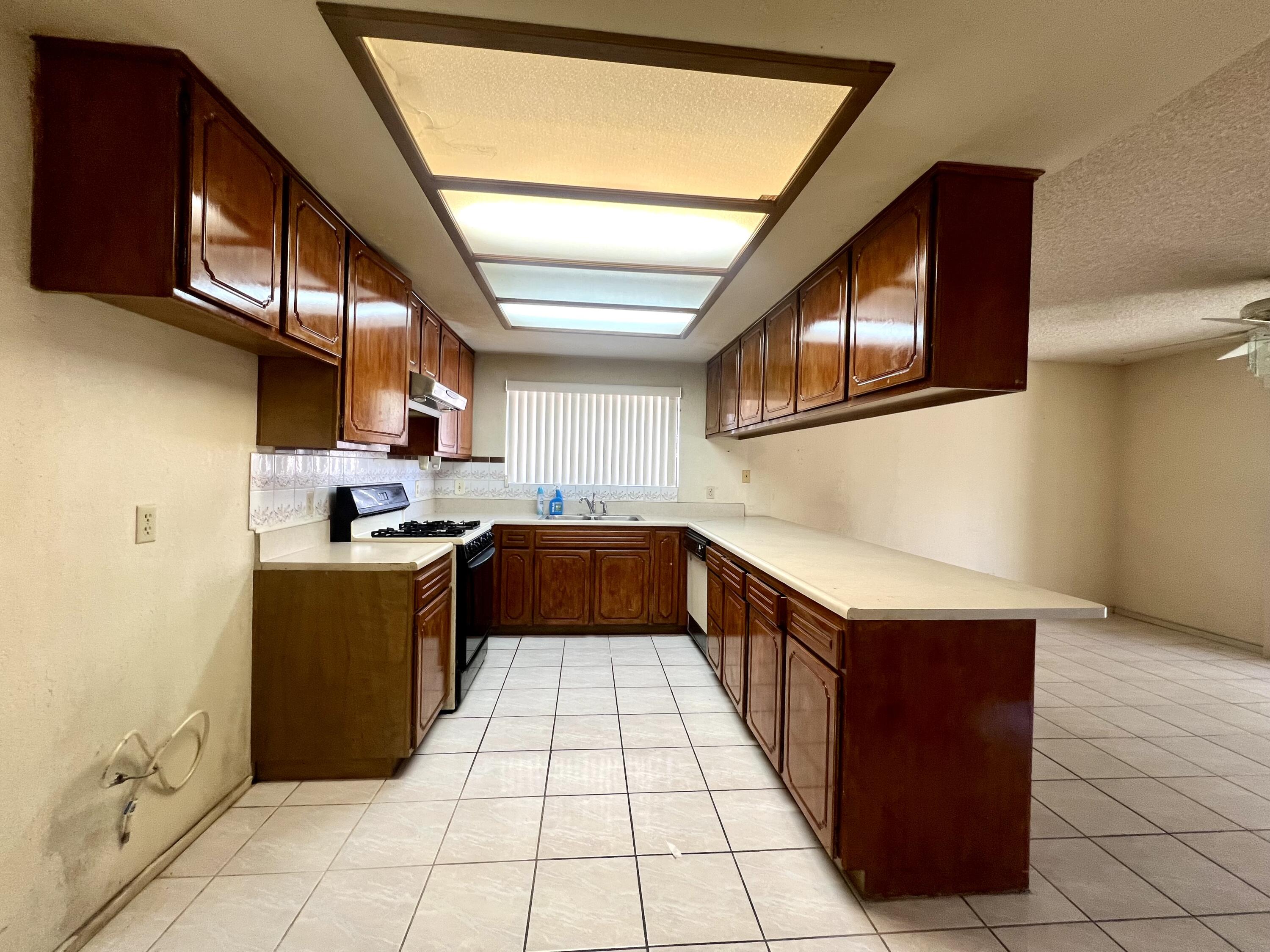 67690 Peineta Road Cathedral City, CA 92234 - Photo 4 of 7 a kitchen with stainless steel appliances granite countertop a refrigerator and a stove