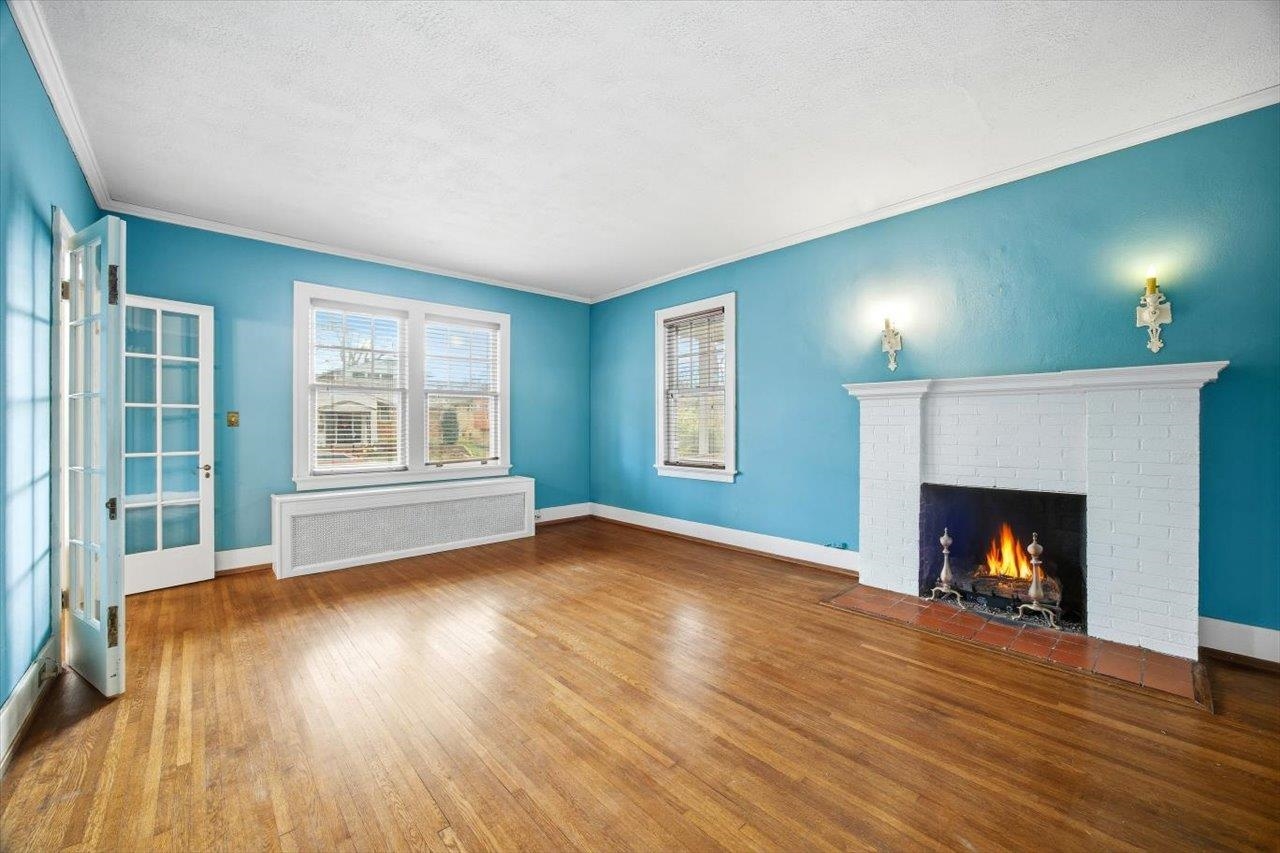 645 Maple Avenue Waynesboro, VA 22980 - Photo 7 of 63 a view of an empty room with wooden floor fireplace and a window