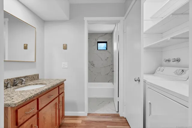 a utility room with a sink dryer and washer