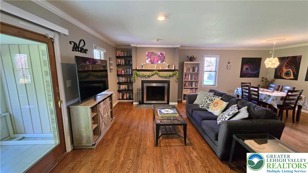 194 Springhouse Road Allentown, PA 18104 - Photo 6 of 34 This inviting space features rich hardwood flooring and a charming fireplace, perfect for relaxation and gatherings.