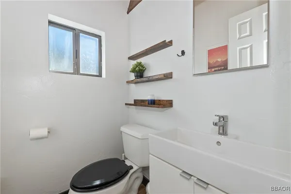 a bathroom with a toilet a sink and a shower