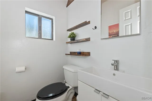 a bathroom with a toilet a sink and a shower