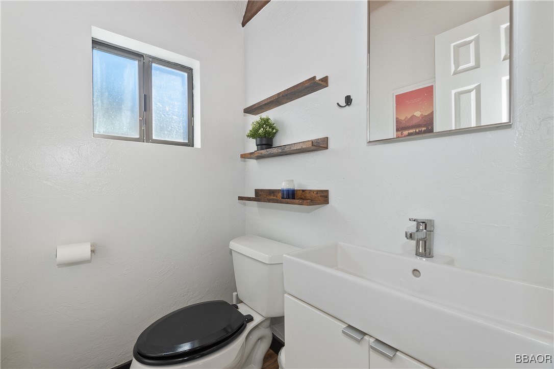 42533 Moonridge Road, Unit 4 Big Bear Lake, CA 92315 - Photo 12 of 37 a bathroom with a toilet a sink and a shower