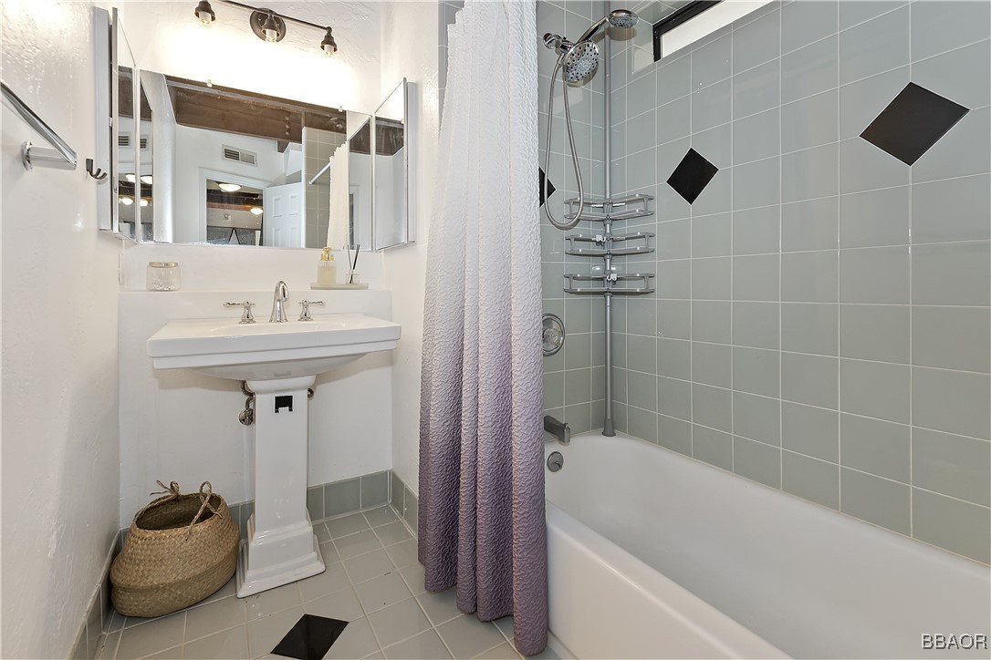 42533 Moonridge Road, Unit 4 Big Bear Lake, CA 92315 - Photo 17 of 37 a bathroom with a sink a toilet and shower