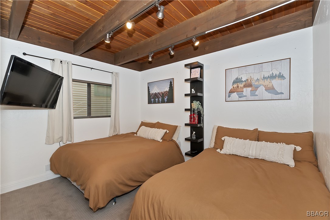 42533 Moonridge Road, Unit 4 Big Bear Lake, CA 92315 - Photo 18 of 37 a bedroom with two beds and a flat screen tv